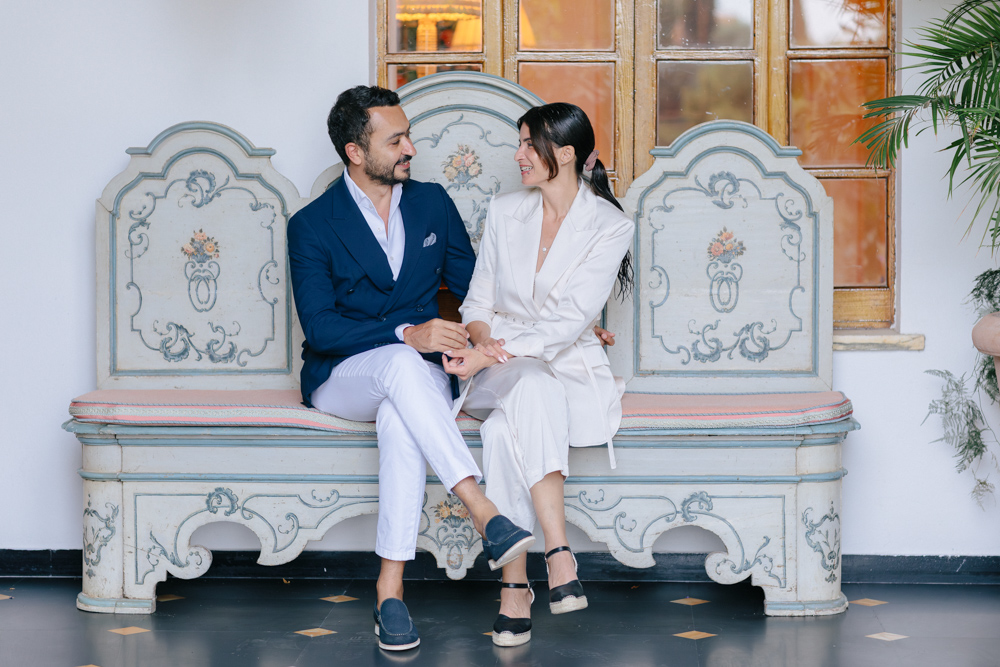 Bride and groom seated together during a couple session at Hotel Splendido