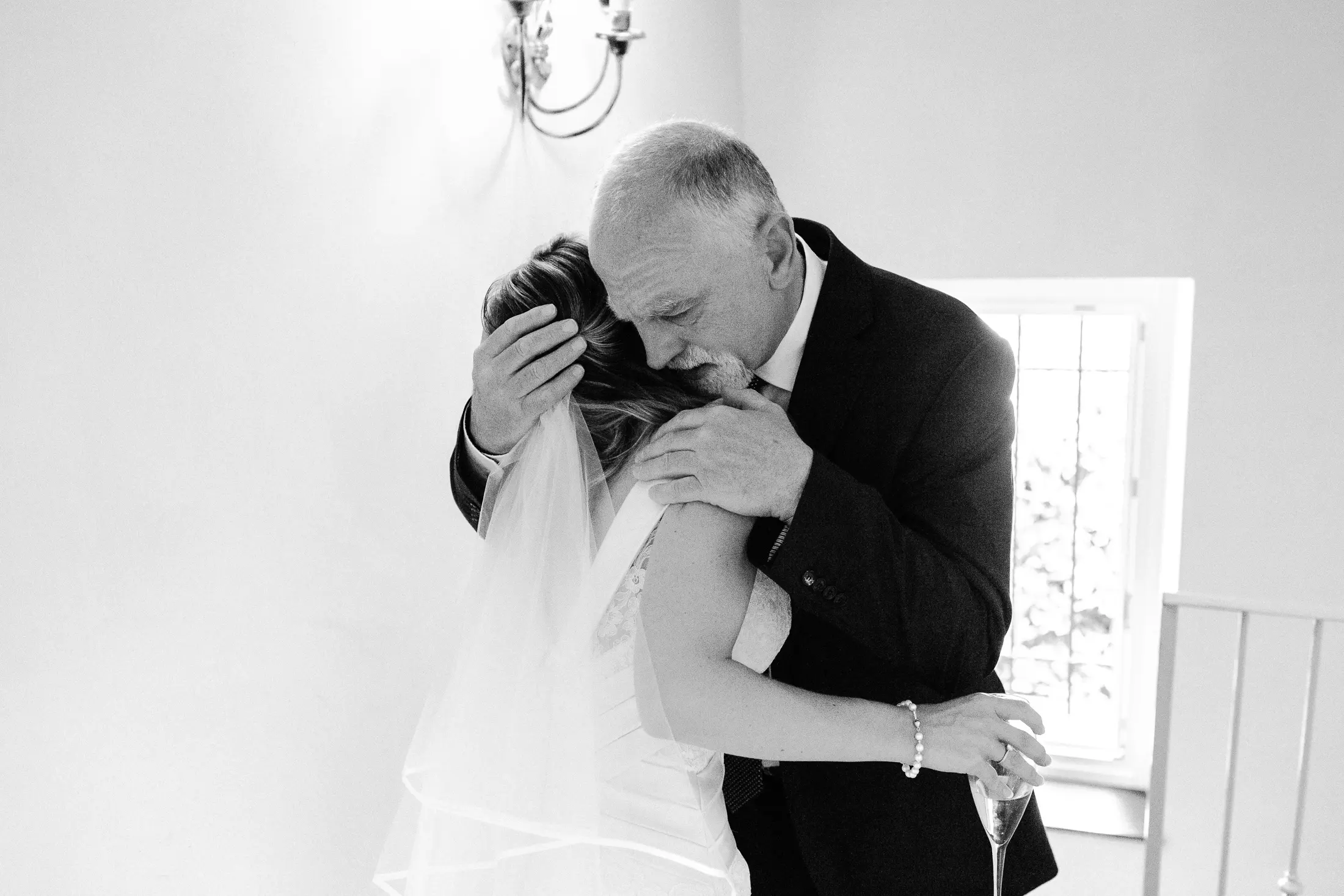 Bride and dad embrace before the wedding ceremony